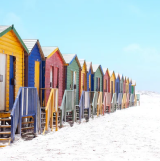 Colorful beach huts on sunny sandy beach