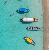 Colorful boats anchored in clear turquoise water