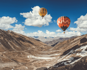 Colorful hot air balloons over mountain landscape