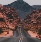 Desert road through rocky mountains landscape