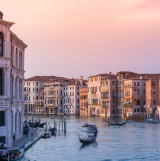 Venice Grand Canal at sunset with gondolas.