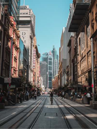 Urban street view with cyclist and tall buildings.