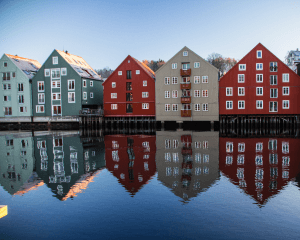 Colorful houses reflecting in calm water.