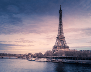 Eiffel Tower at sunset by the Seine River.