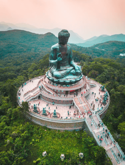 Aerial view of Tian Tan Buddha statue, green landscape.