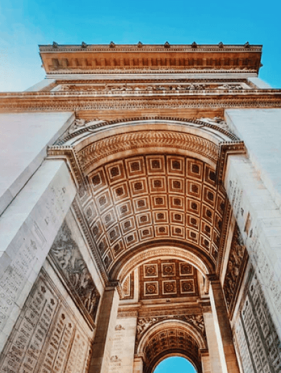 Low-angle view of Arc de Triomphe in Paris.