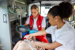 Paramedics perform CPR in ambulance